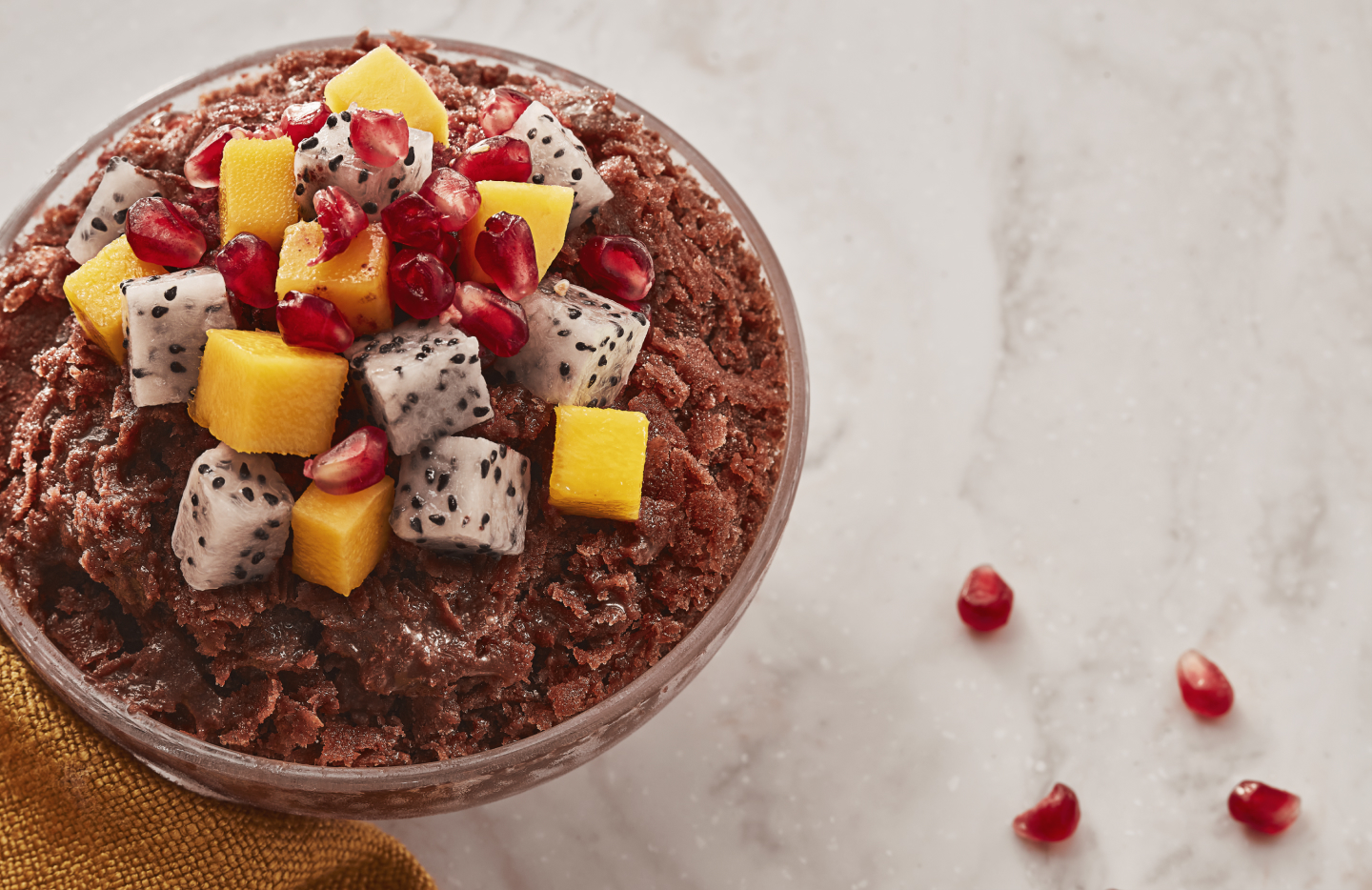 Shaved ice dessert with chopped fruit, pomegranate seeds and other toppings Shaved ice dessert with chopped fruit, pomegranate seeds and other toppings